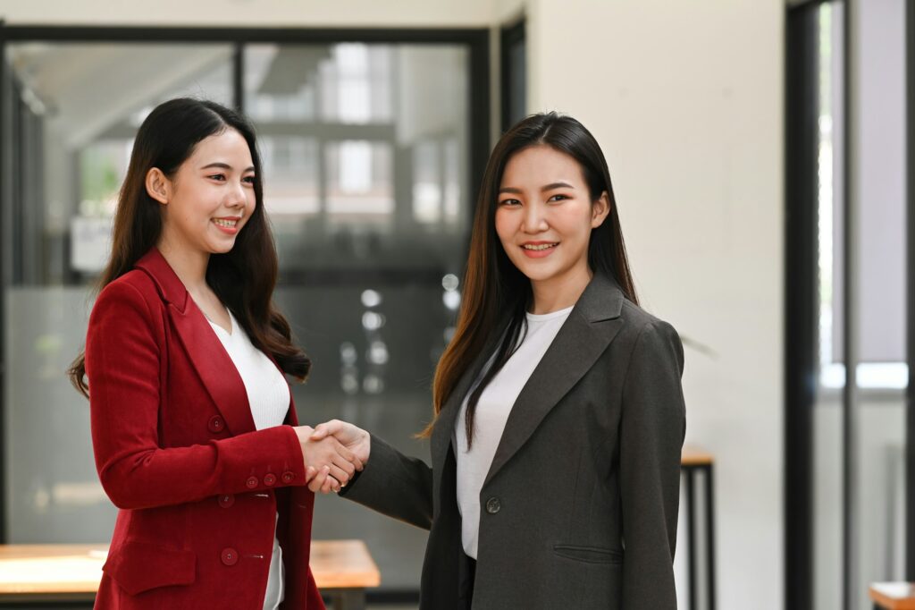 Business partners shaking hands after negotiations.