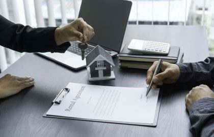 The hand of a real estate agent hand over the keys to the new landlord after signing a contract to r